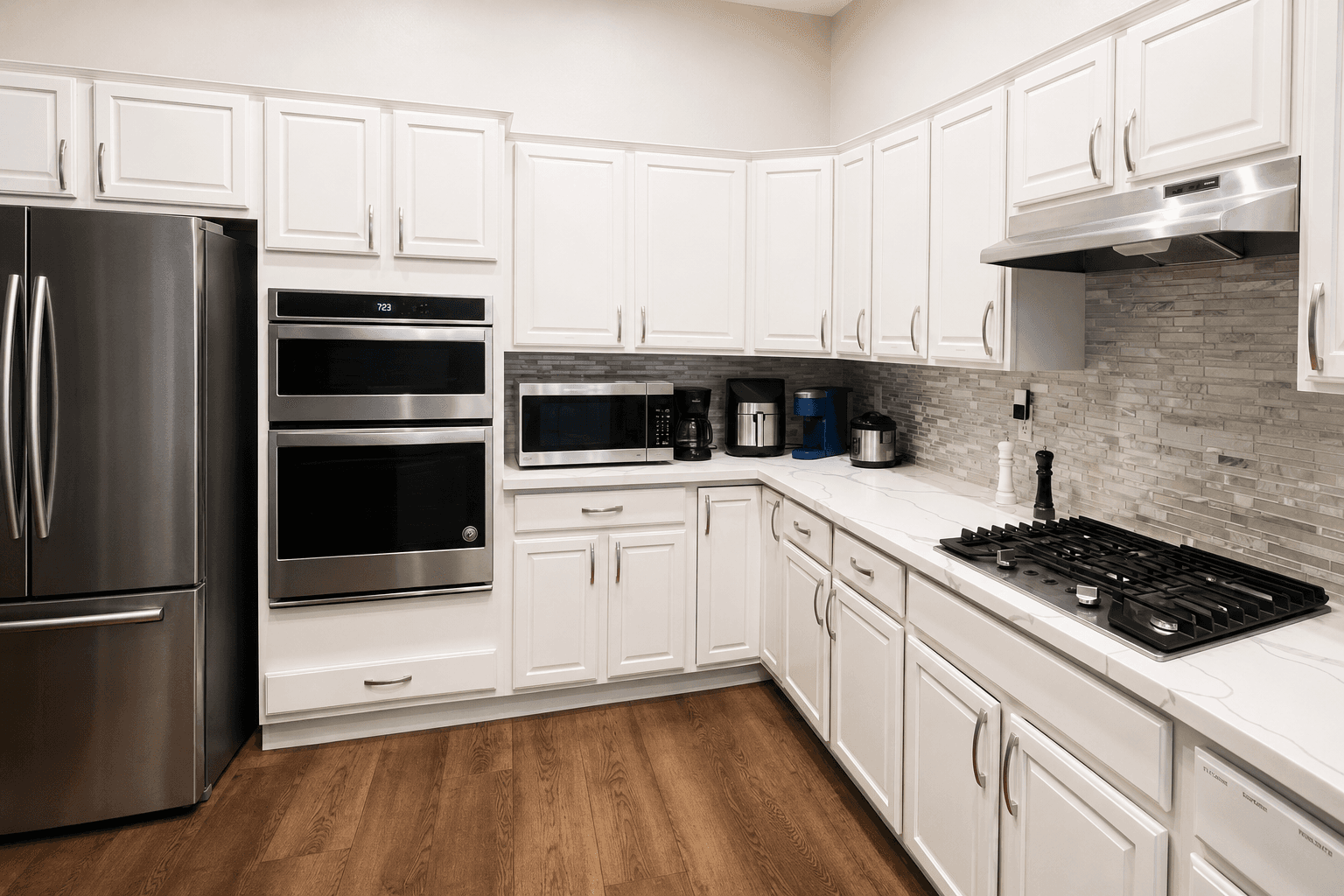 Kitchen at Joy in Caring II with white cabinetry and stone countertops