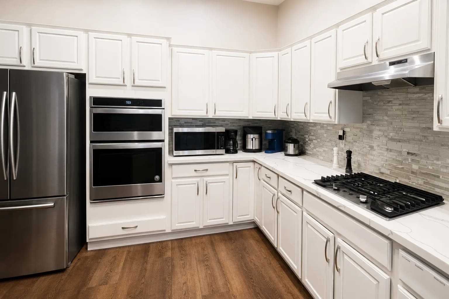 Kitchen at Joy in Caring II with white cabinetry and stone countertops