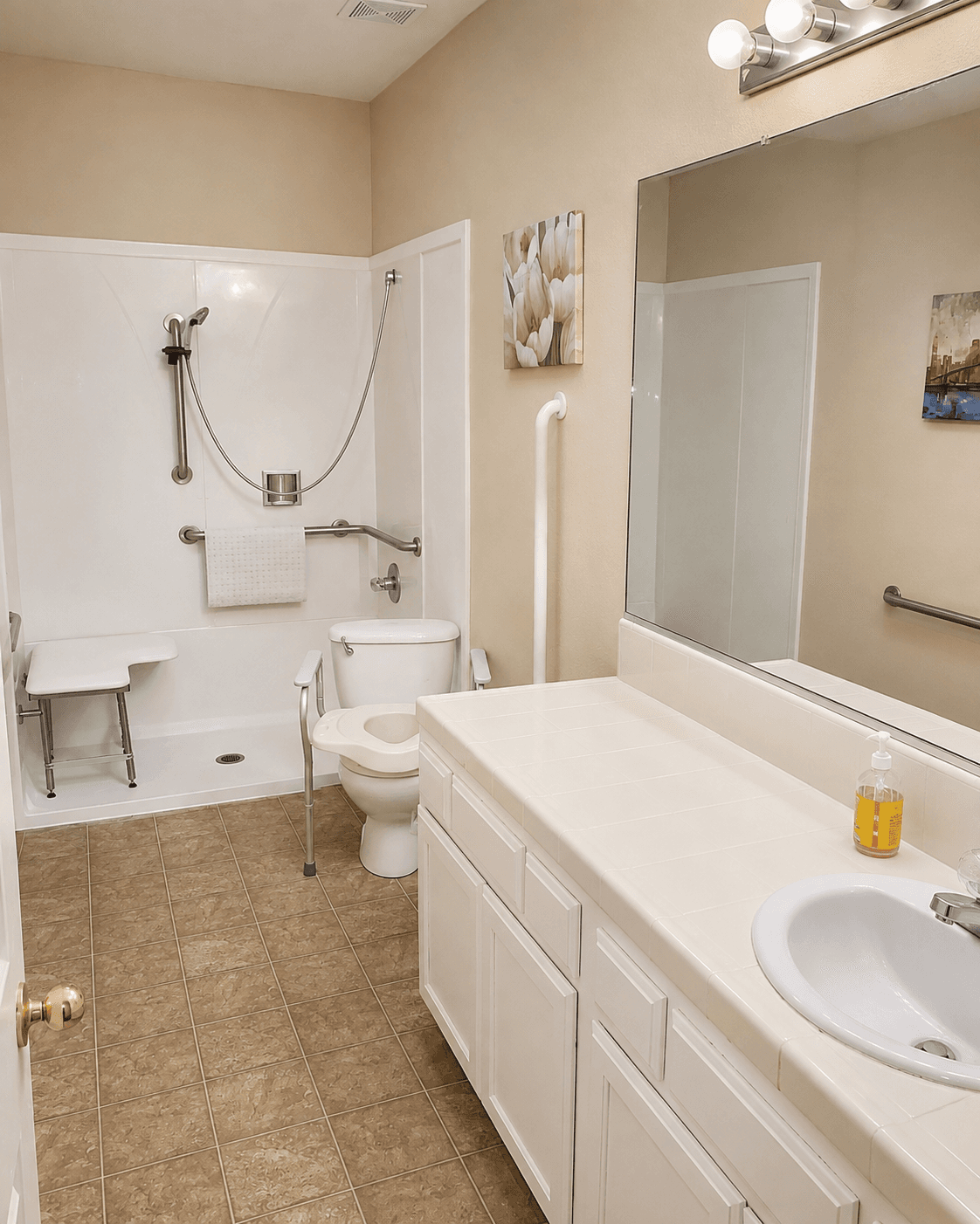 Accessible bathroom at Joy in Caring with grab bars, a roll-in shower and shower seat