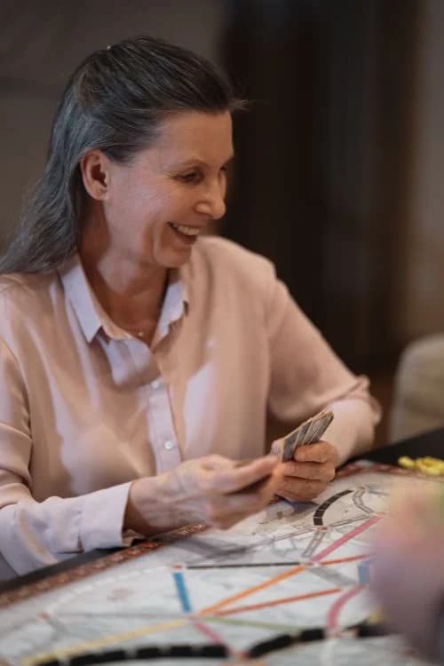 Illustrative stock photo: An older woman enjoying a board game