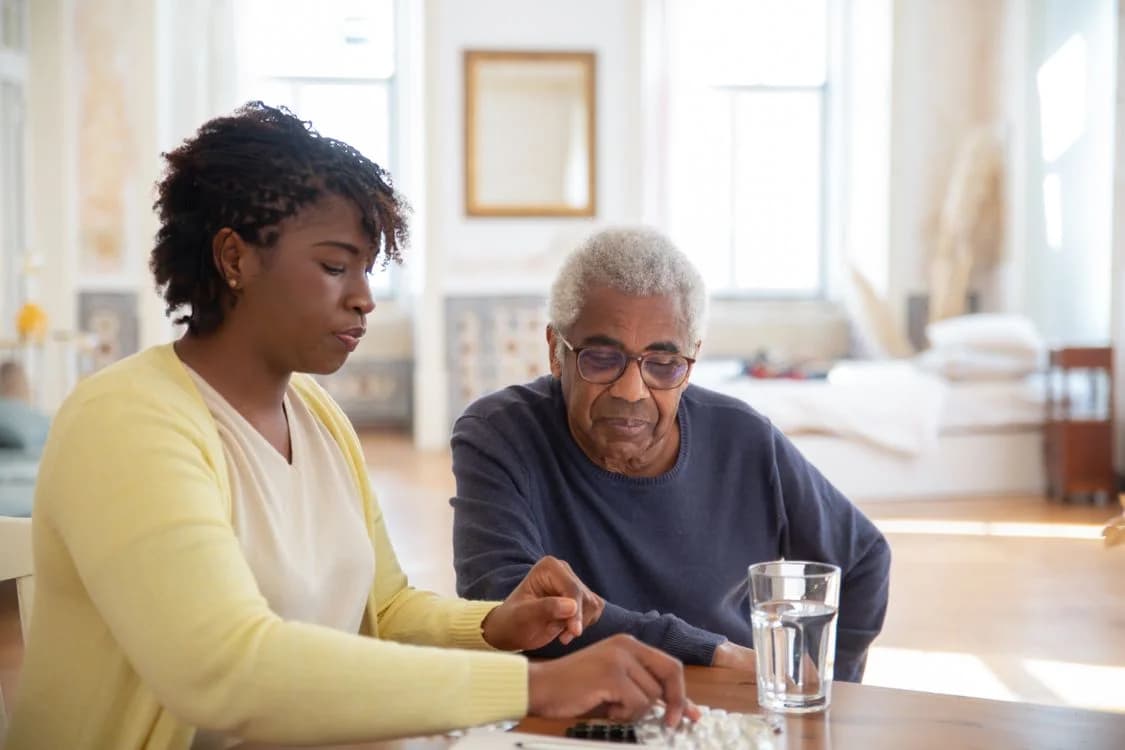Illustrative stock photo: Two adults reviewing medication together